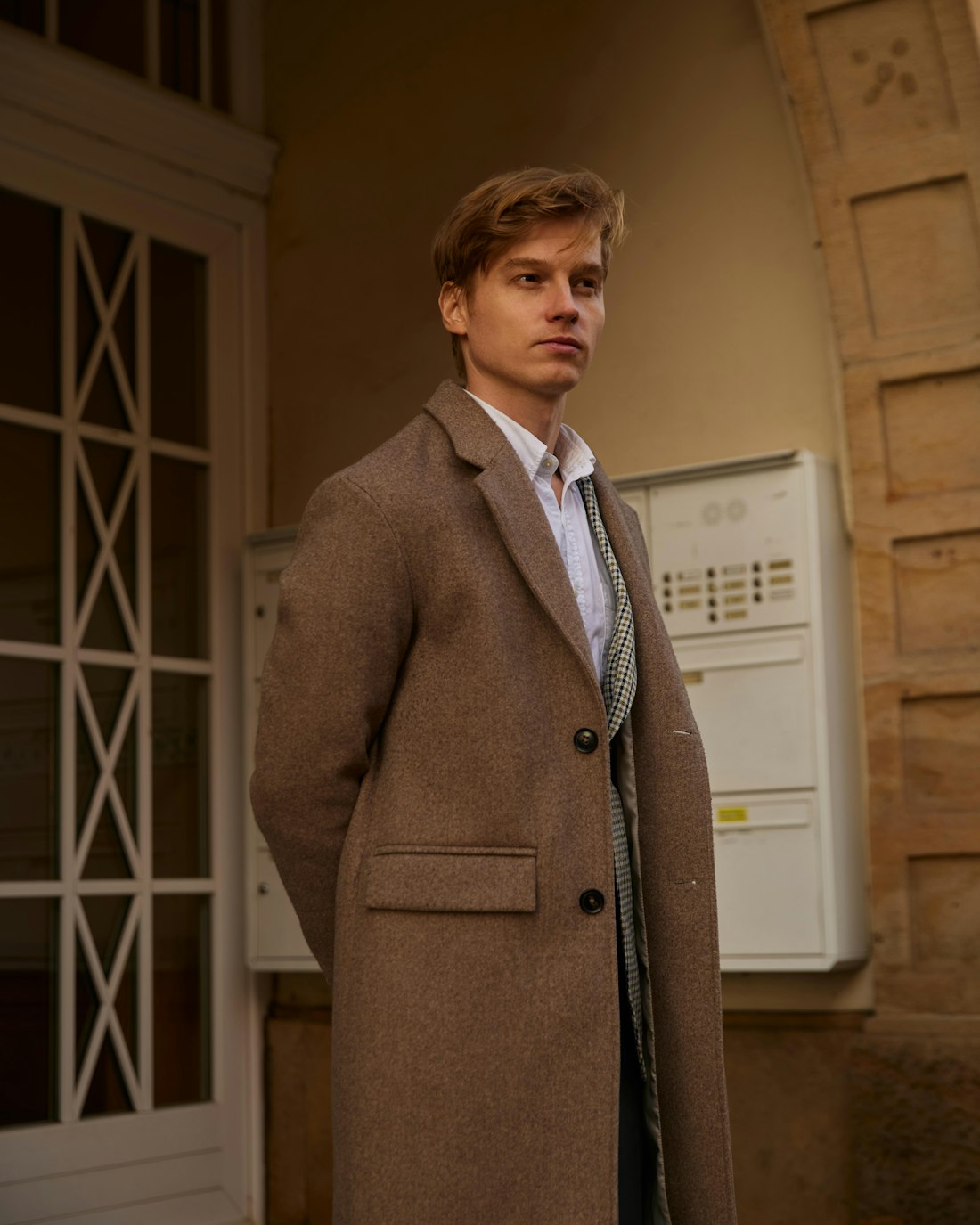Man in a long camel overcoat