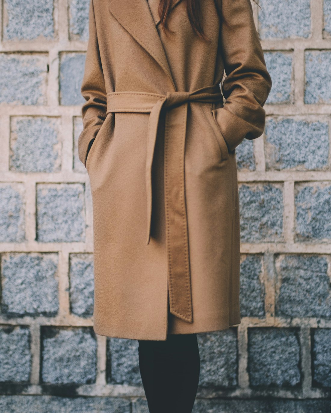 Woman in a belted camel wool coat